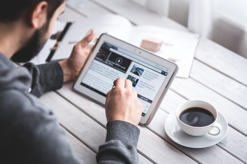 person looking at display advertising website on tablet