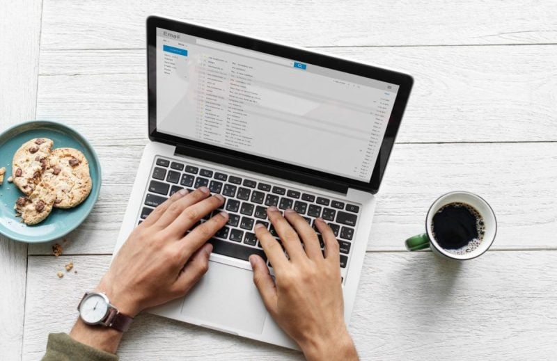 person typing on laptop
