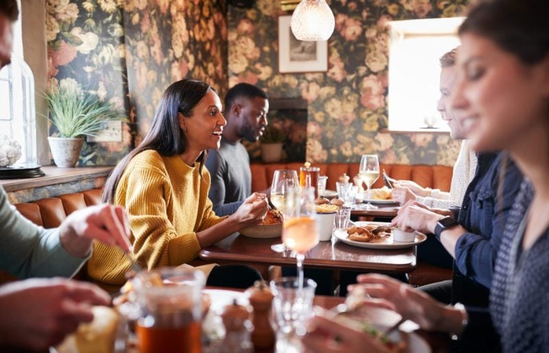 people eating in restaurant at multiple tables