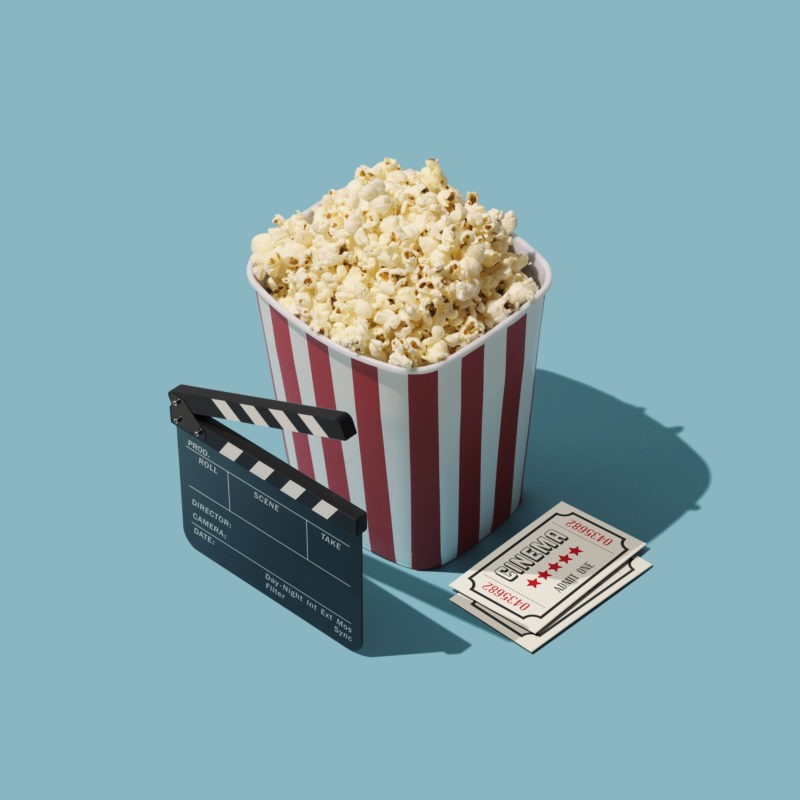 popcorn with movie tickets and clapperboard
