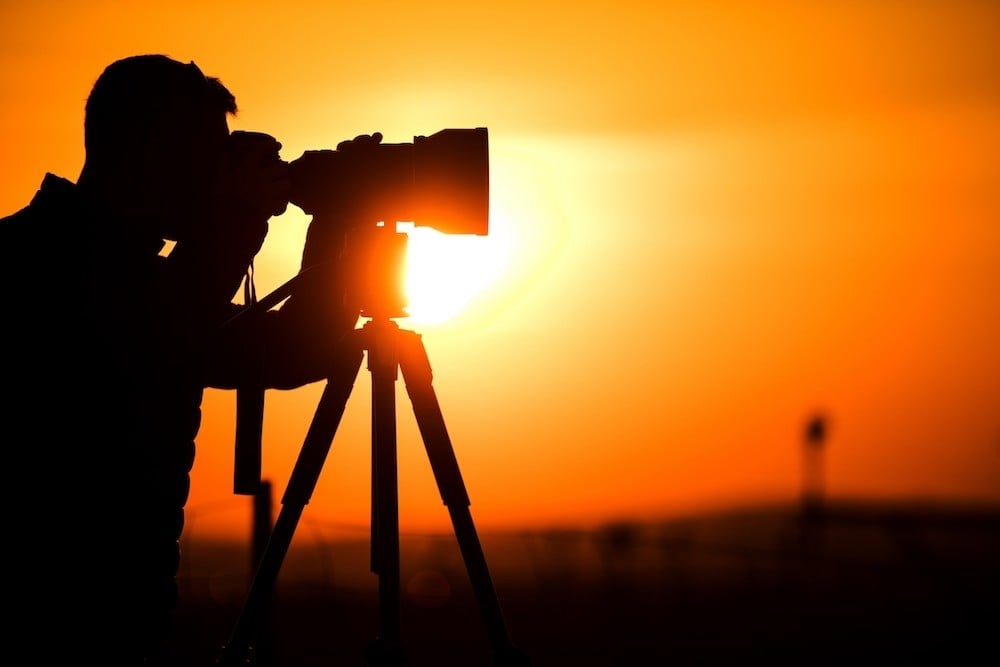 photographer taking photos at sunset