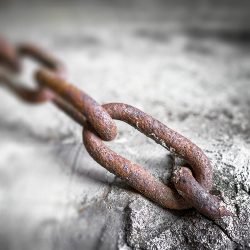 rusty chain stuck in cement