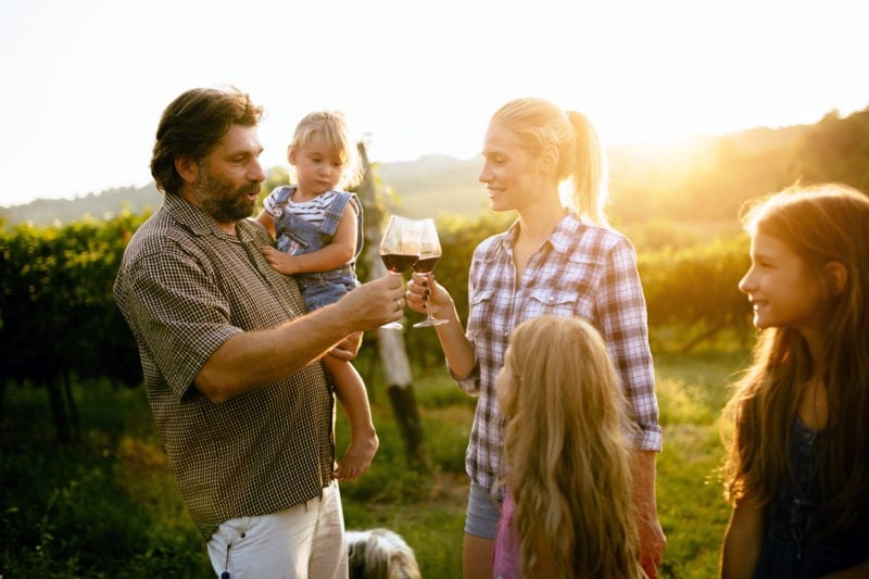 man and woman toasting red wine
