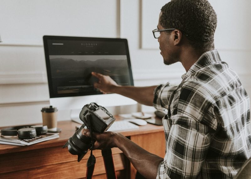 Photographer checking photo on computer