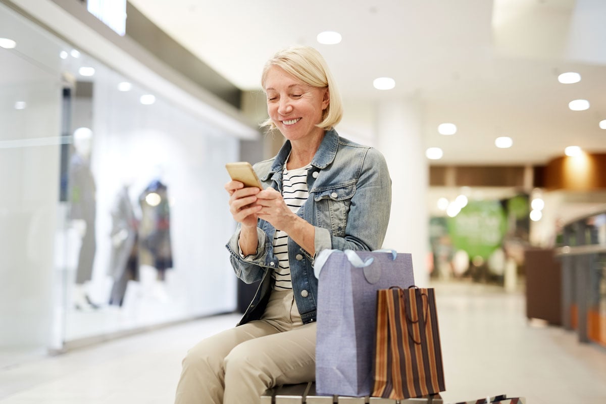happy woman looking at sale on social media