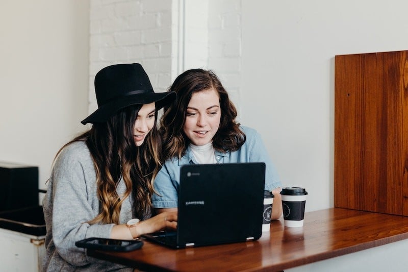two girls working on laptop