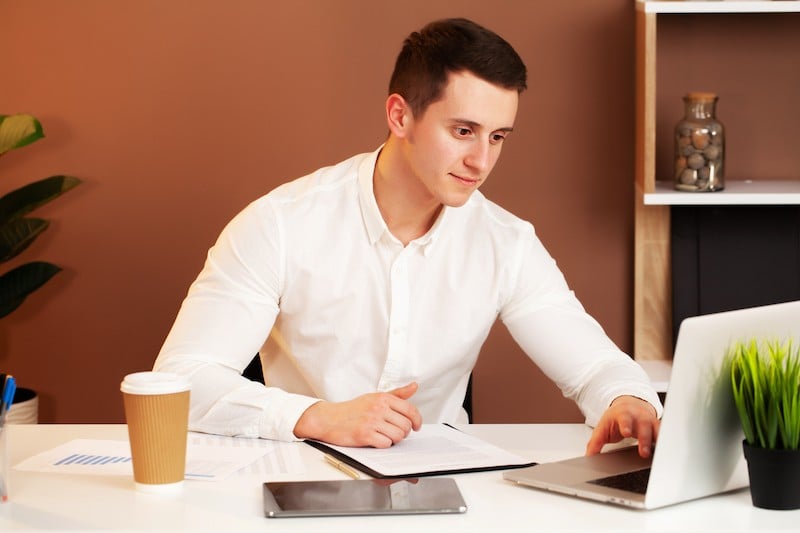 young man works on laptop
