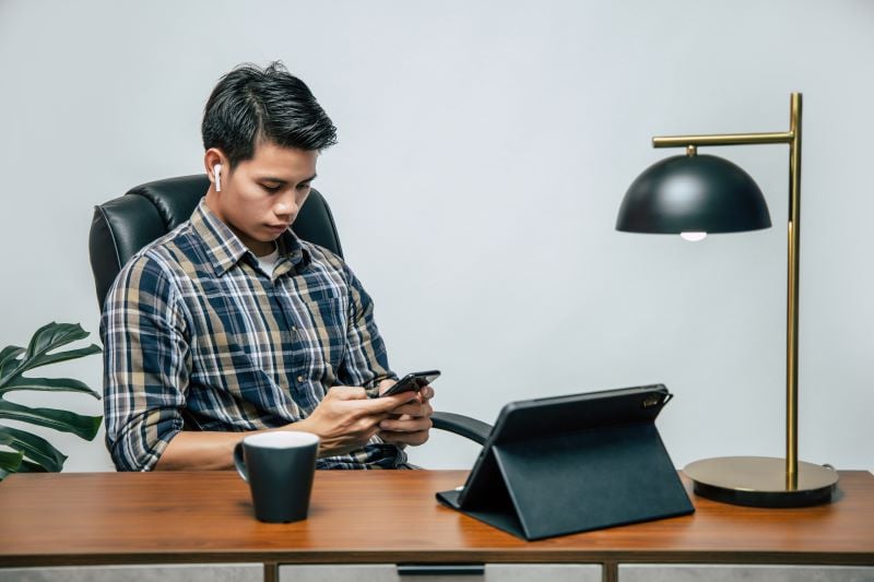 man works on his phone