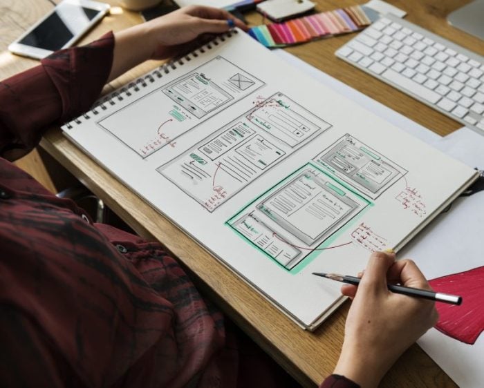 Fashion designer drawing, working in a studio