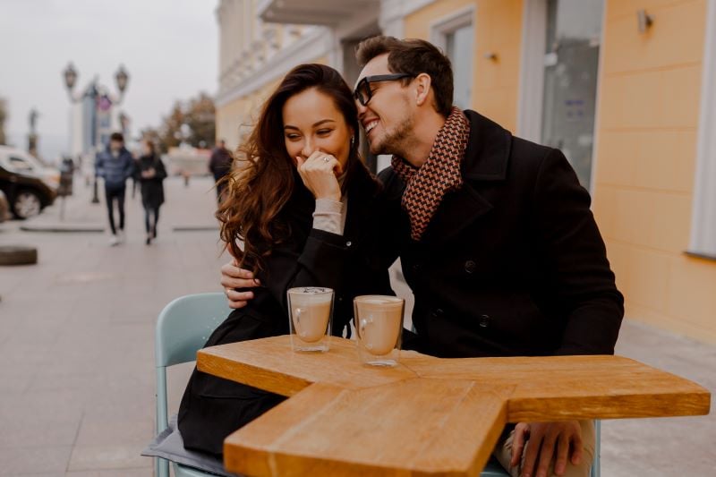 couple in love sitting in street cafe