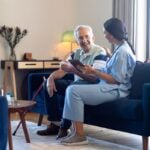 female physiotherapist talking with a senior