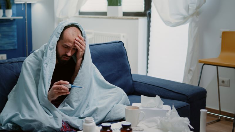 ill person wrapped in blanket