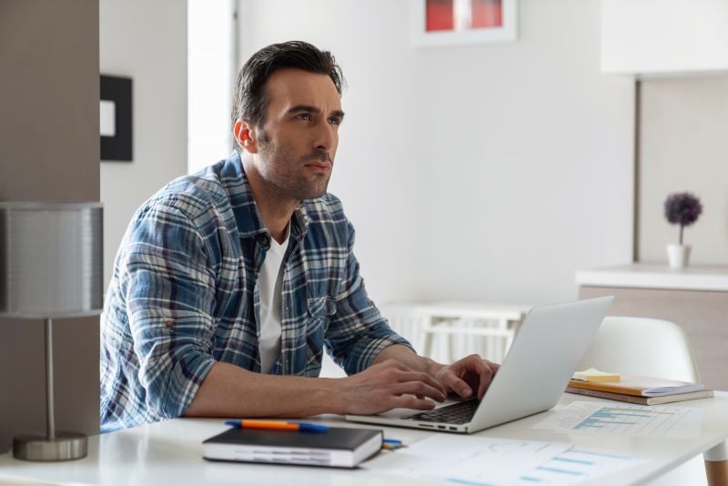 man works on laptop