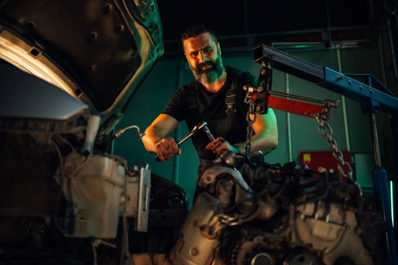 mechanic working on car engine