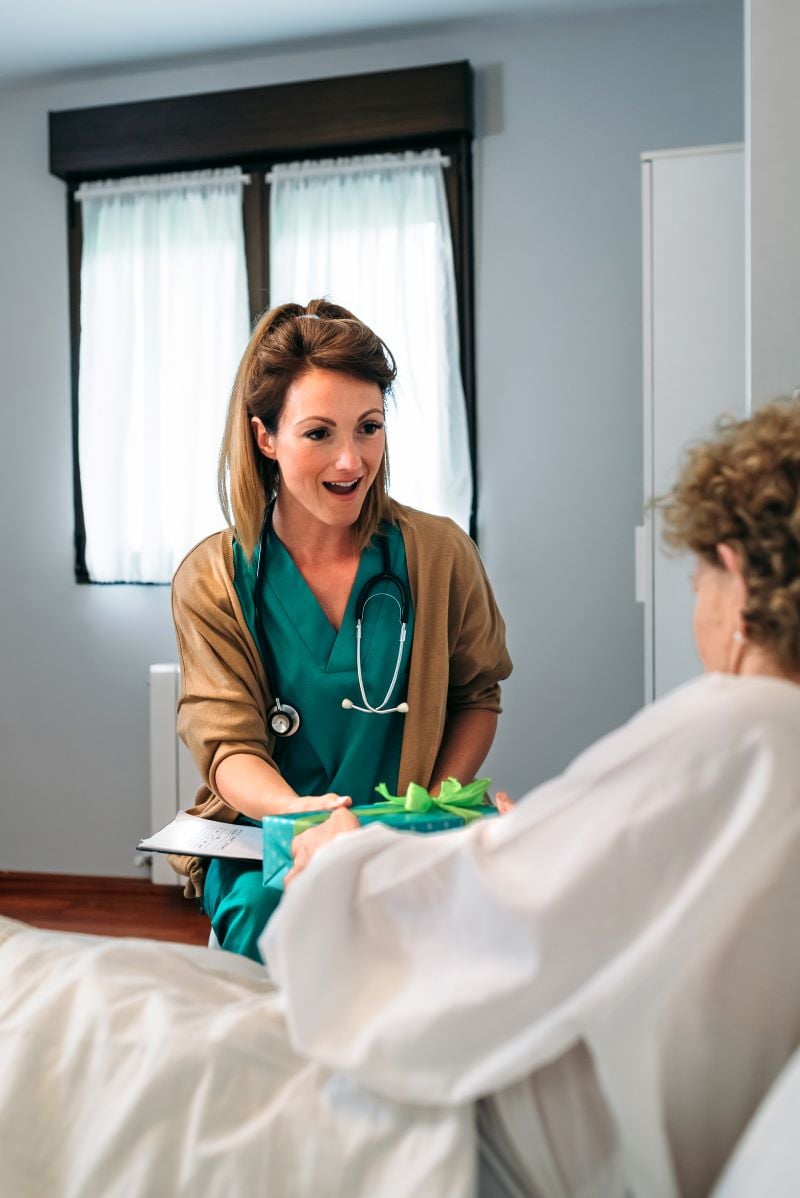 senior patient giving a gift to her doctor