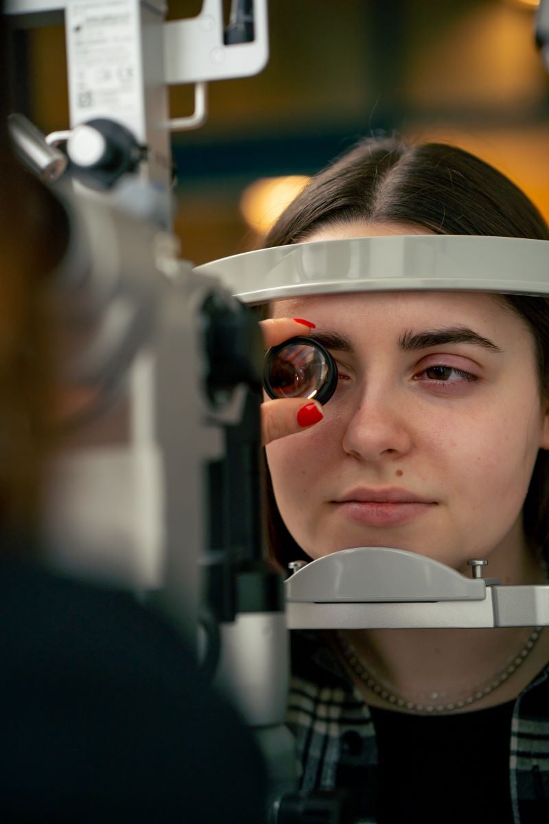 young girl checking her eyes