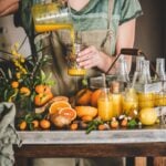 young woman pouring juice