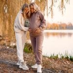 adult daughter hugs her pregnant mom