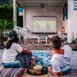 couple looking movie in garden