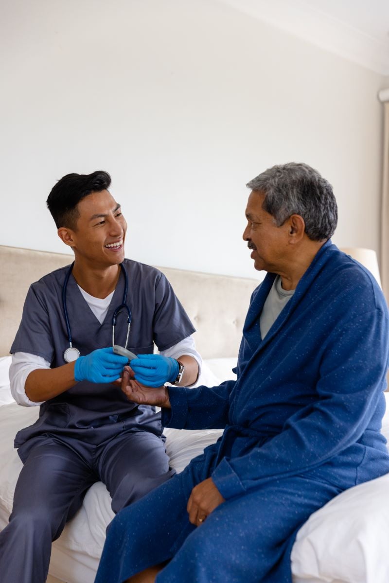 doctor testing blood of senior man