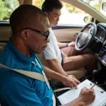 instructor filling evaluation checklist