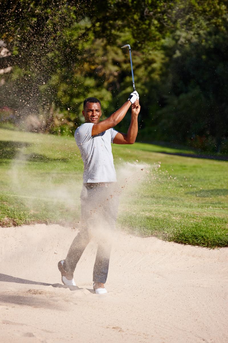 man plays golf