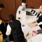 people arriving at hotel front desk