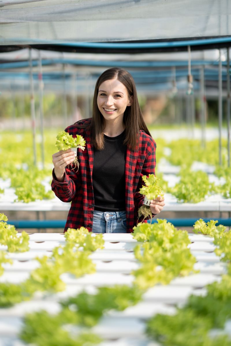 portrait of young woman working in vegetables