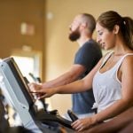 three people using treadmills in gym