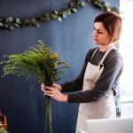 young creative woman in a flower shop