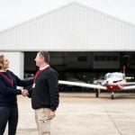 female-flight-instructor congratulating her student
