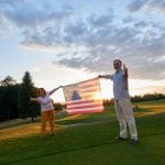 couple holding us flag at Country Club