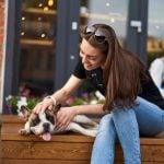 cheerful woman resting with french bulldog