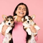 happy girl holding puppies