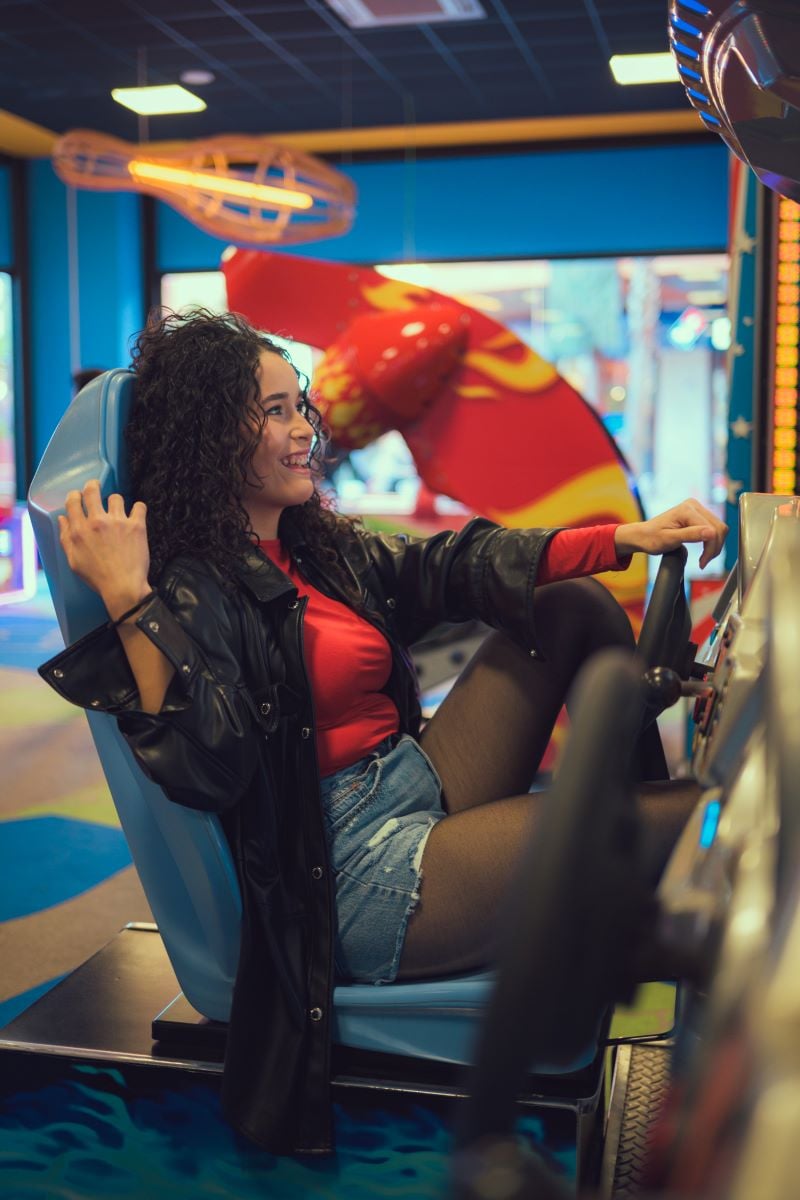 woman sitting in chair playing video game