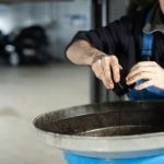 mechanic is changing oil and fuel filter