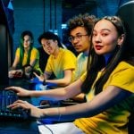 young friends playing videogame