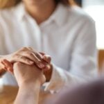women holding each other hands