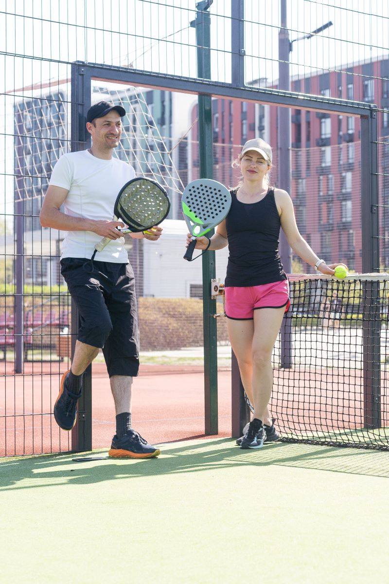 young sporty woman and man playing pickleball