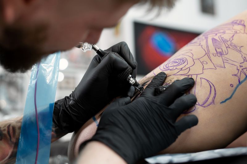 close up image of the bearded tattoo male artist