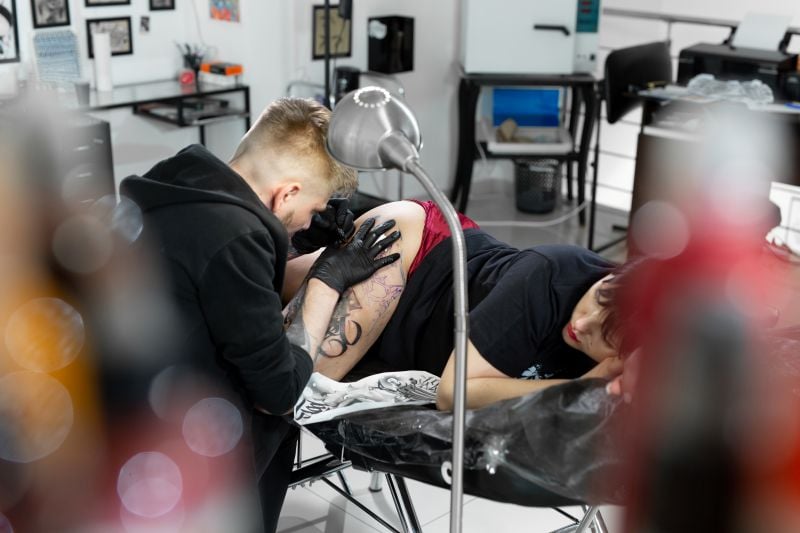 professional-tattoo artist-makes a tattoo on a you