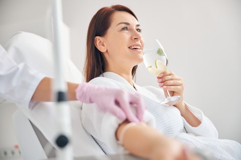 woman smiling during the iv therapy